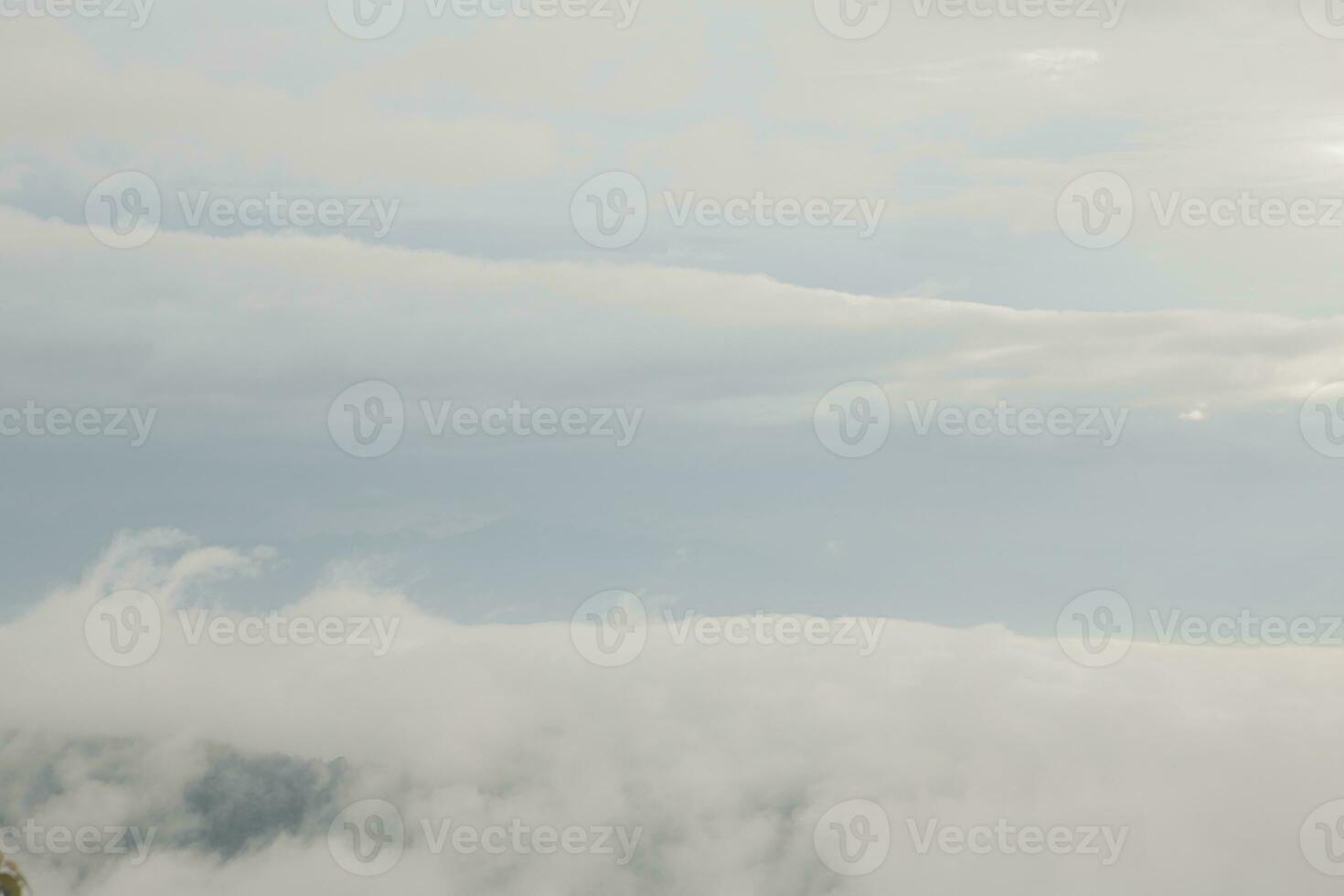 Mountain range with visible silhouettes through the morning blue fog. photo