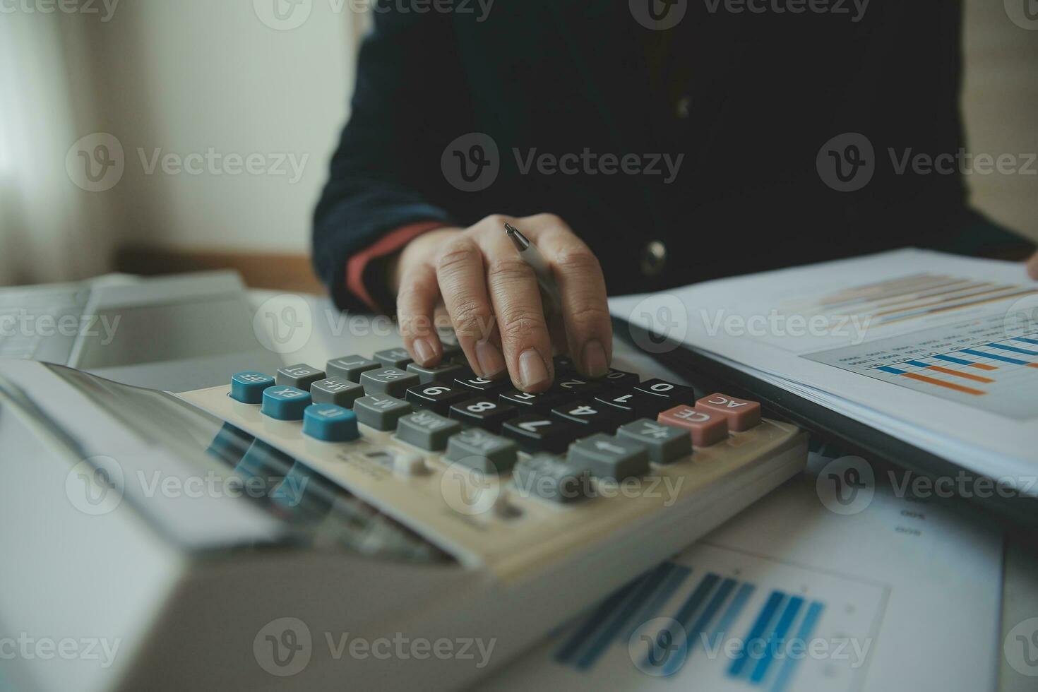 Unrecognizable businessman using calculator photo