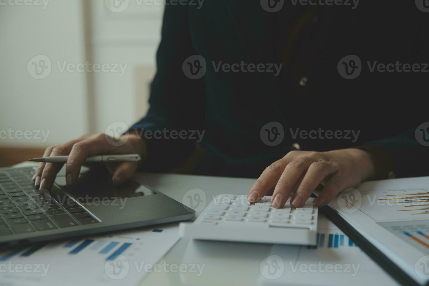 Unrecognizable businessman using calculator photo