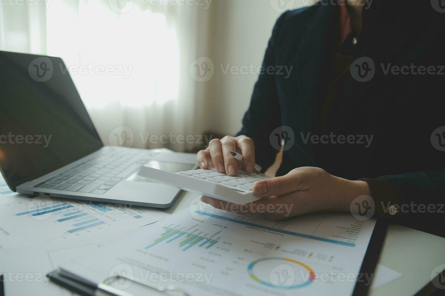 Unrecognizable businessman using calculator photo