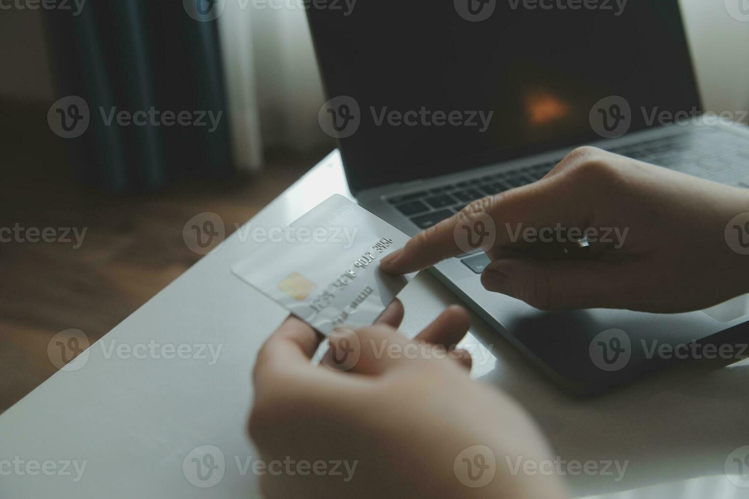 Woman hands holding and using cradit card for shopping online. photo