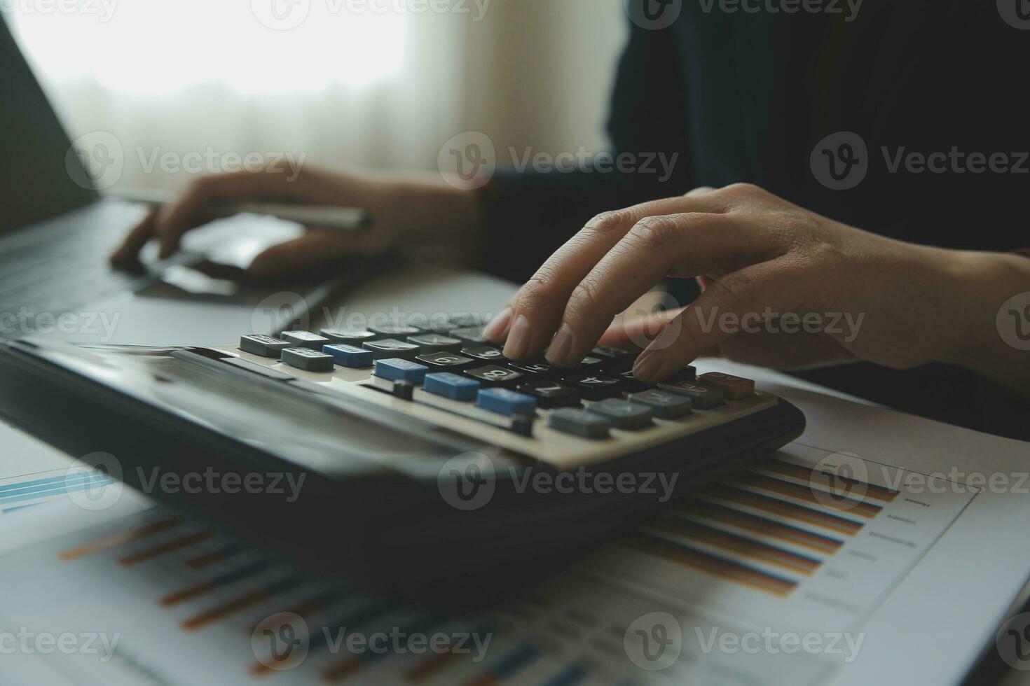 Unrecognizable businessman using calculator photo