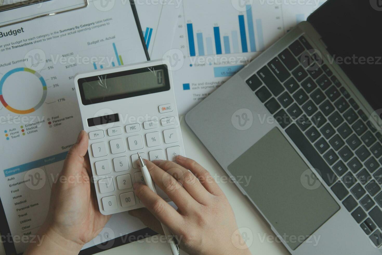 Unrecognizable businessman using calculator photo