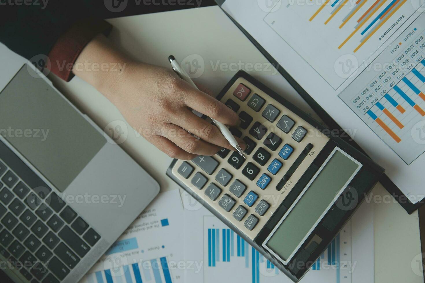 Unrecognizable businessman using calculator photo