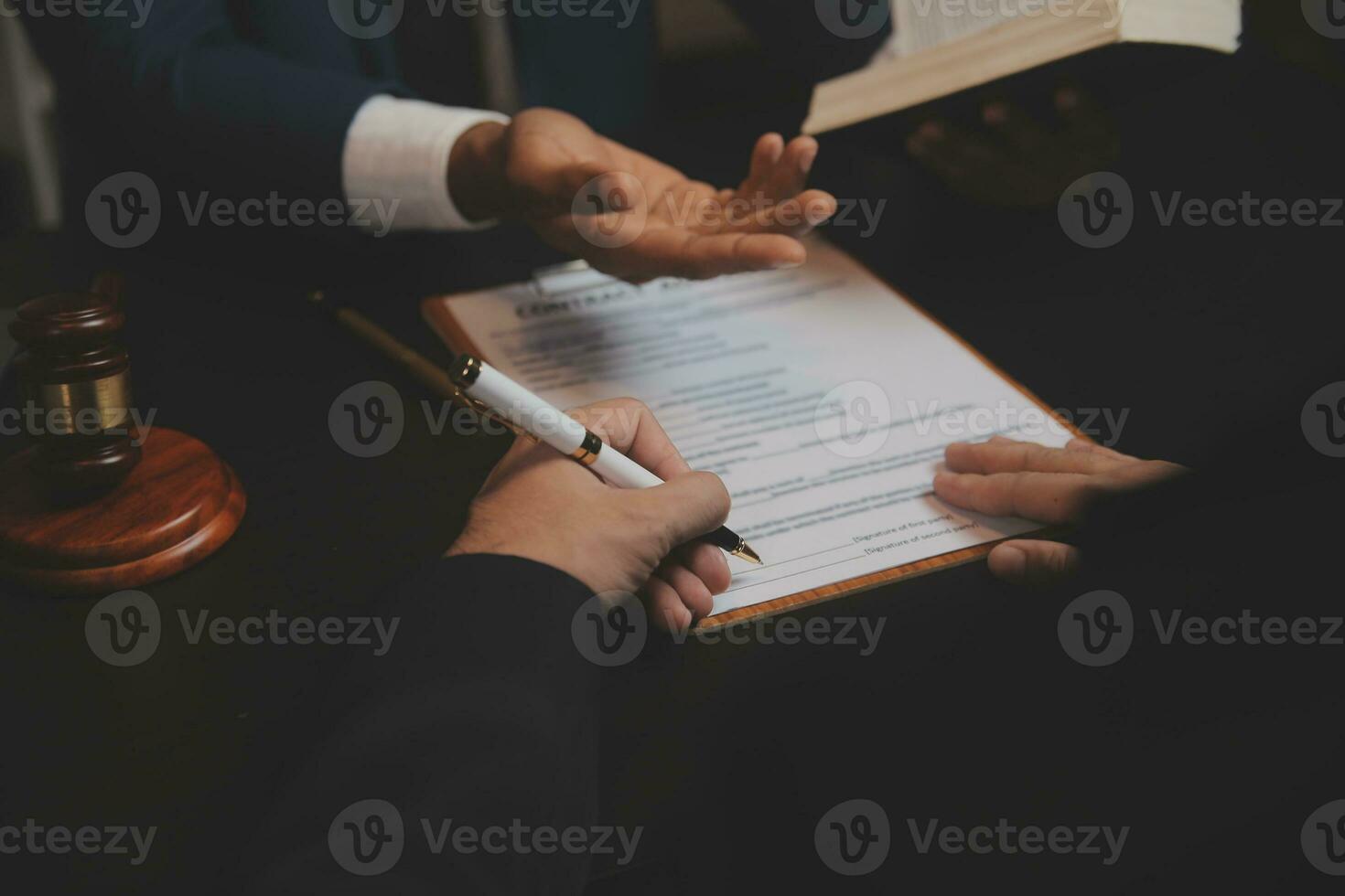 Business and lawyers discussing contract papers with brass scale on desk in office. Law, legal services, advice, justice and law concept picture with film grain effect photo