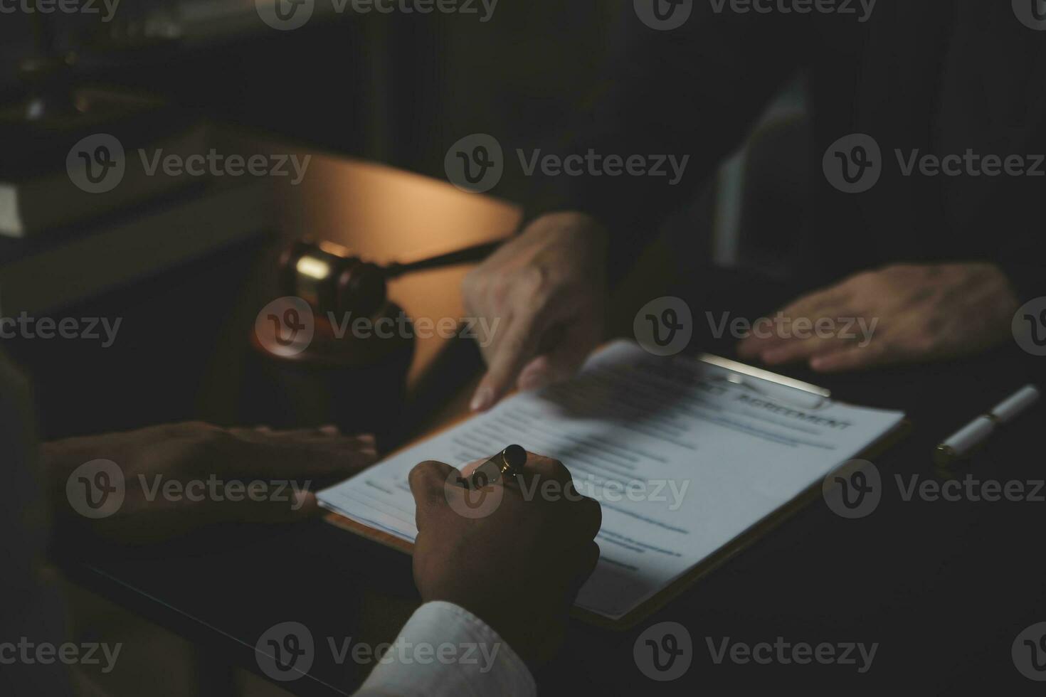 Business and lawyers discussing contract papers with brass scale on desk in office. Law, legal services, advice, justice and law concept picture with film grain effect photo