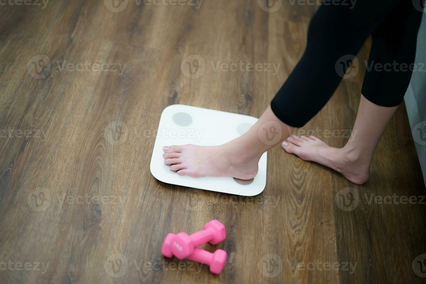 Fat diet and scale feet standing on electronic scales for weight control. Measurement instrument in kilogram for a diet control photo