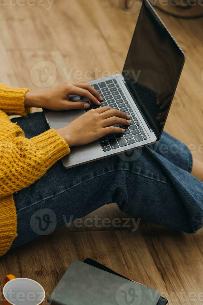Young adult happy smiling Hispanic Asian student wearing headphones talking on online chat meeting using laptop in university campus or at virtual office. College female student learning remotely. photo