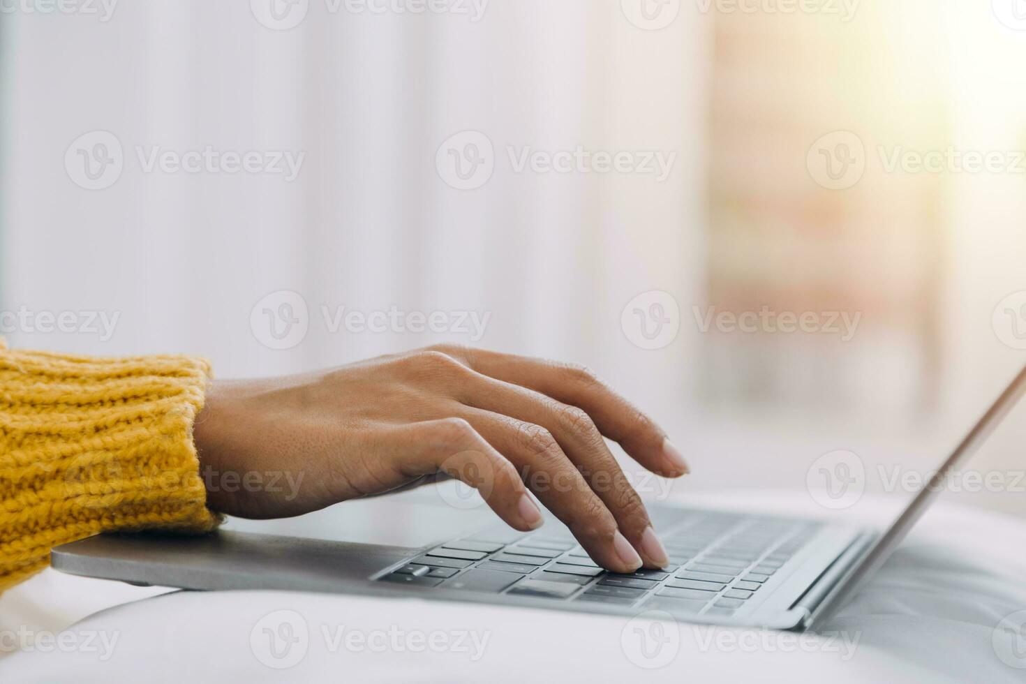 Young adult happy smiling Hispanic Asian student wearing headphones talking on online chat meeting using laptop in university campus or at virtual office. College female student learning remotely. photo