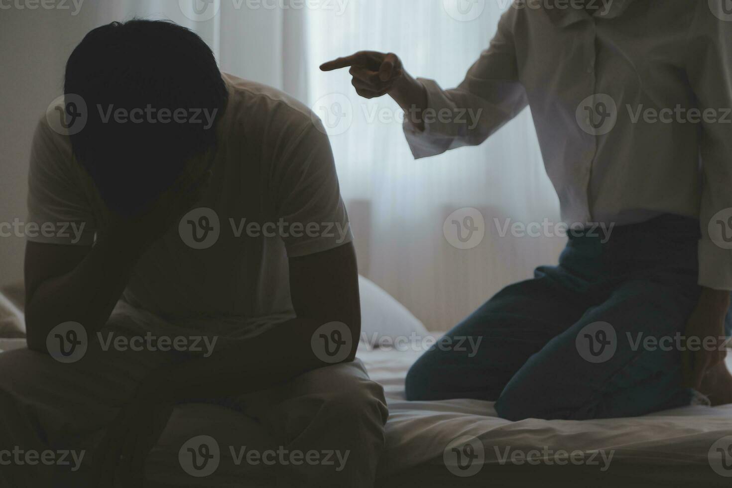 Upset woman having a fight with a man at home. Hispanic wife slapping the face of her husband during an argument because of their relationship problems photo