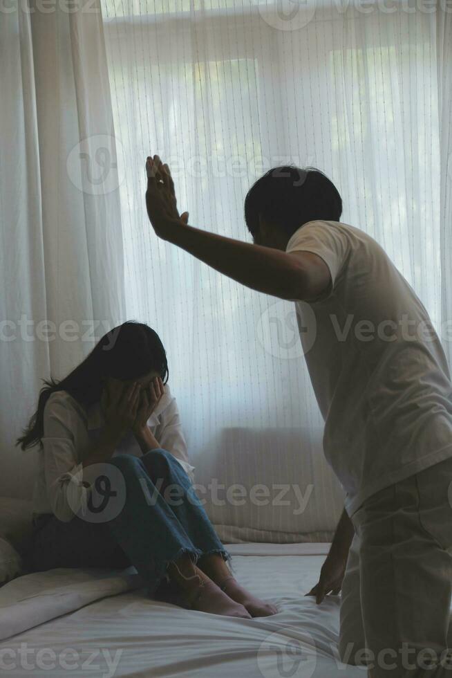 Upset woman having a fight with a man at home. Hispanic wife slapping the face of her husband during an argument because of their relationship problems photo