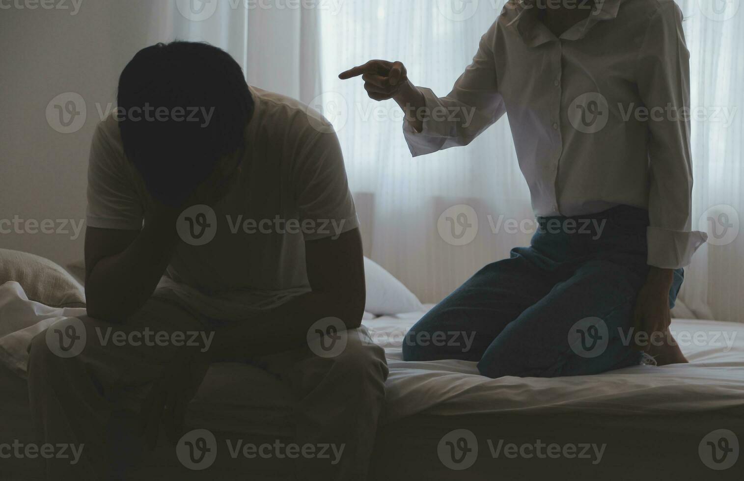 Upset woman having a fight with a man at home. Hispanic wife slapping the face of her husband during an argument because of their relationship problems photo