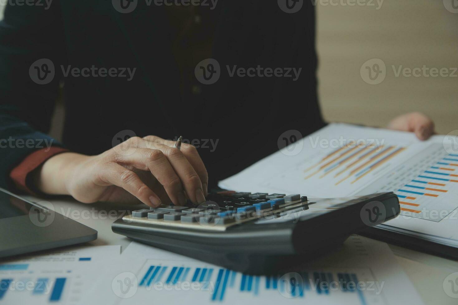 Unrecognizable businessman using calculator photo
