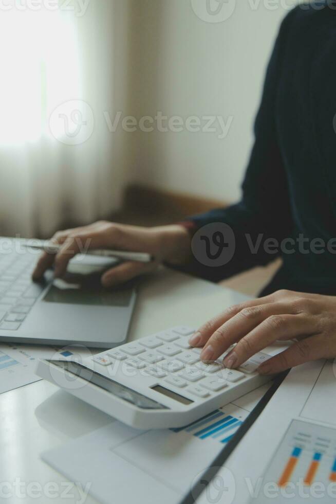 Unrecognizable businessman using calculator photo