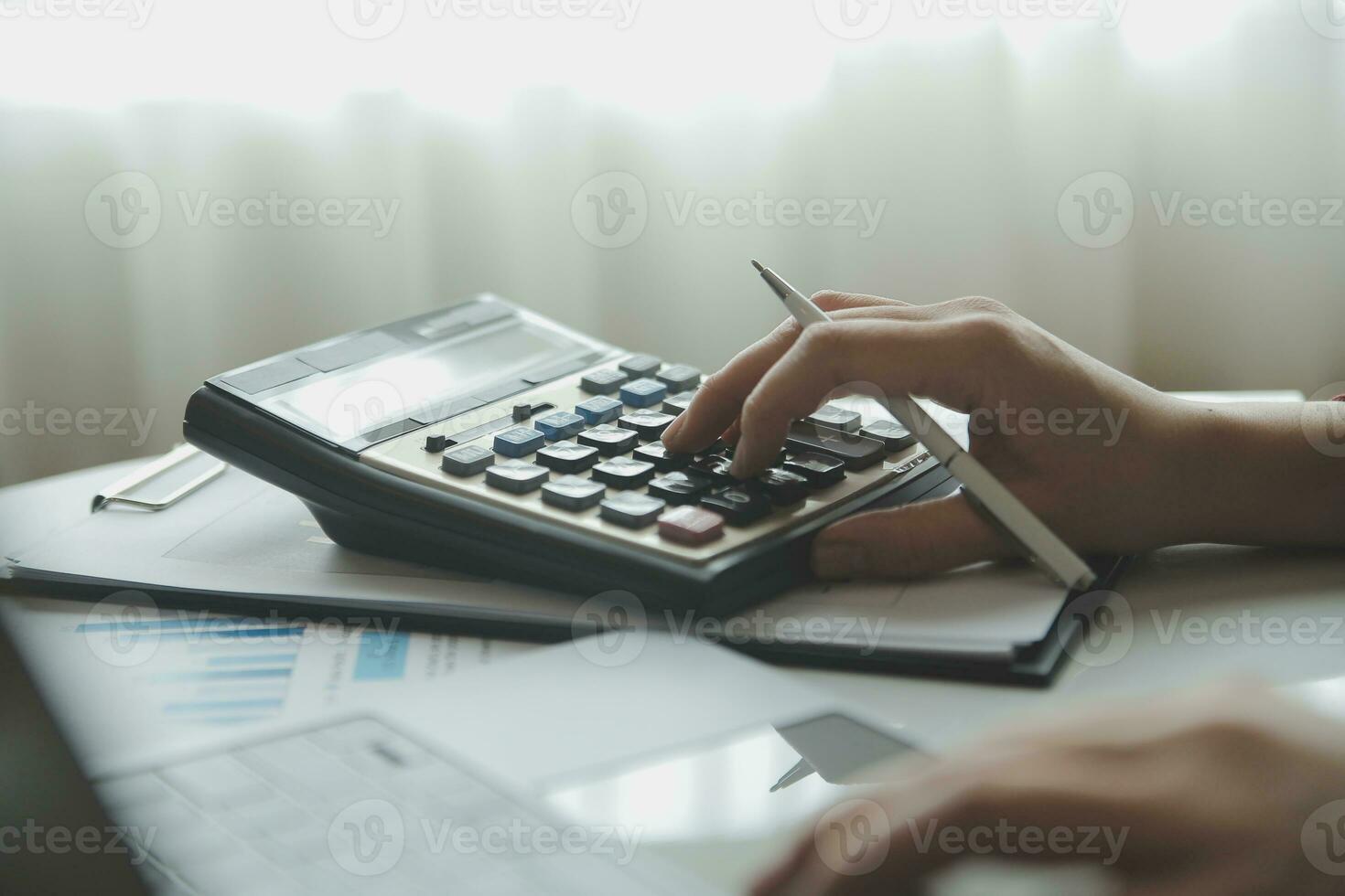 Unrecognizable businessman using calculator photo