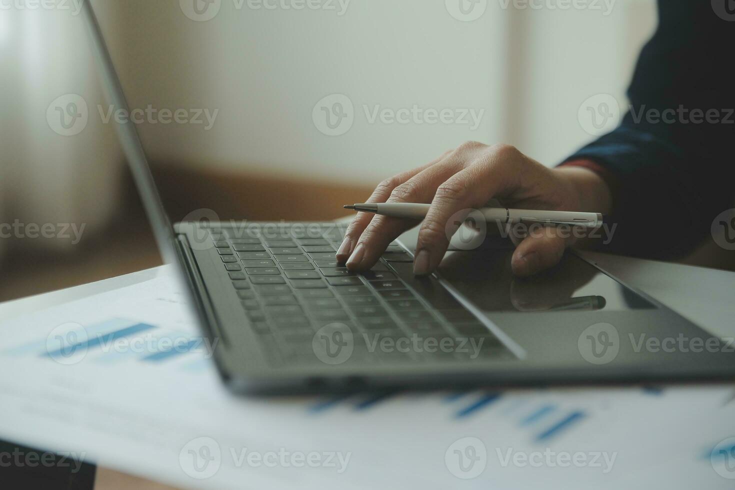 Unrecognizable businessman using calculator photo