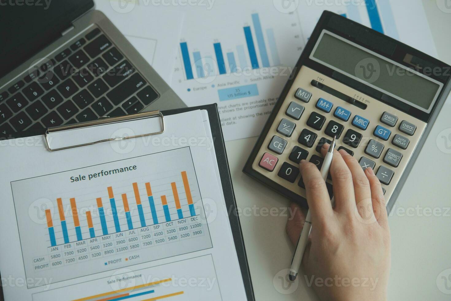 Unrecognizable businessman using calculator photo