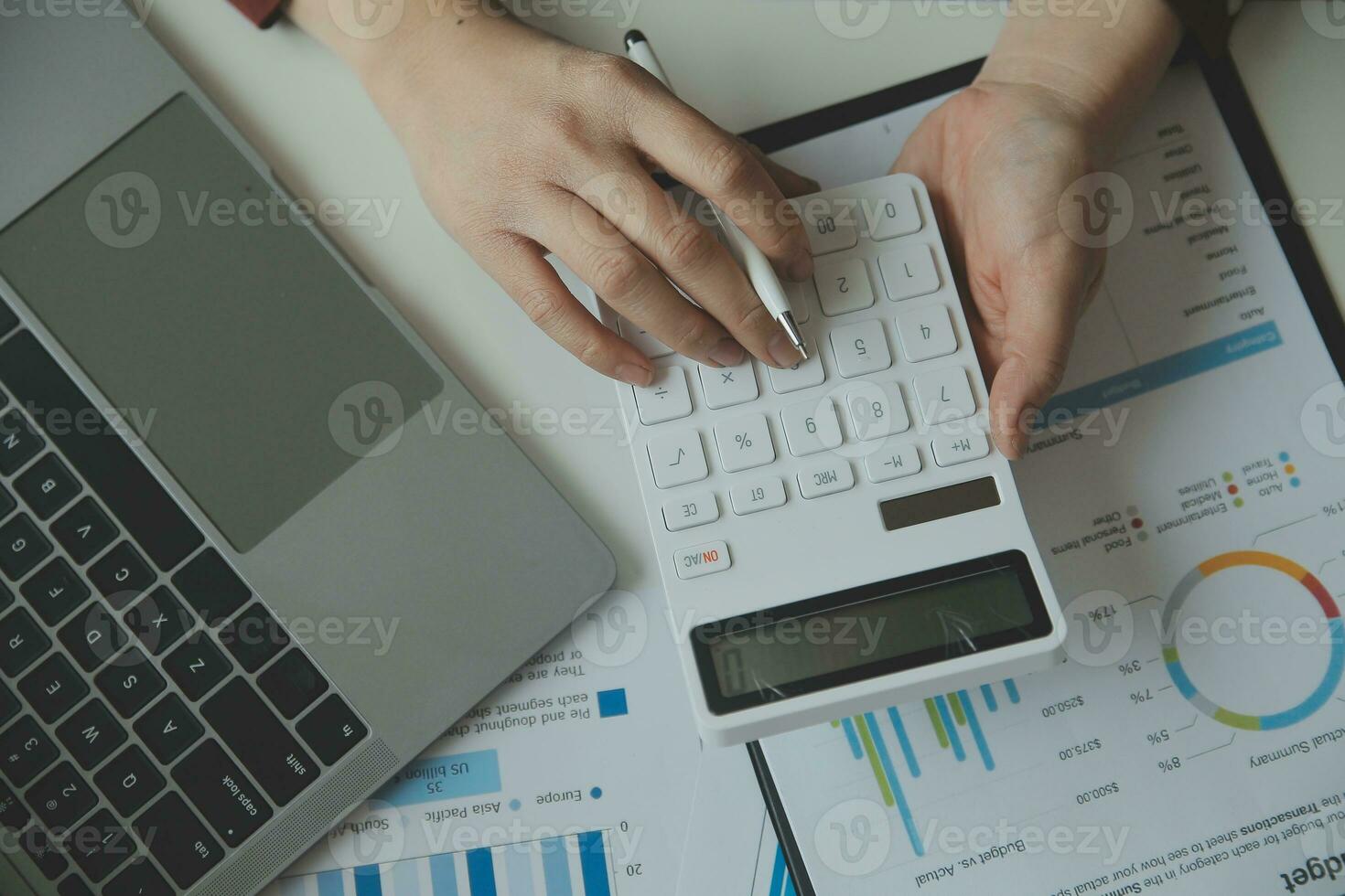 Unrecognizable businessman using calculator photo
