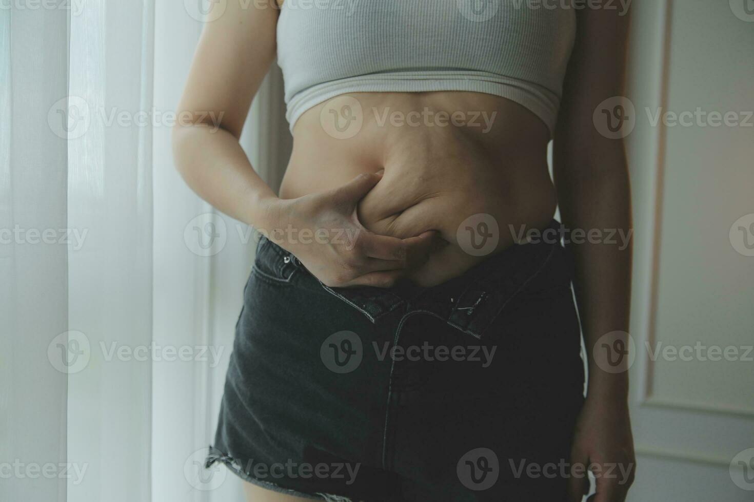 mujer gorda midiendo, mujer gorda gorda vientre gordito panzón deporte recreación cuidado de la salud perder grasa abdominal no hacer ejercicio concepto foto
