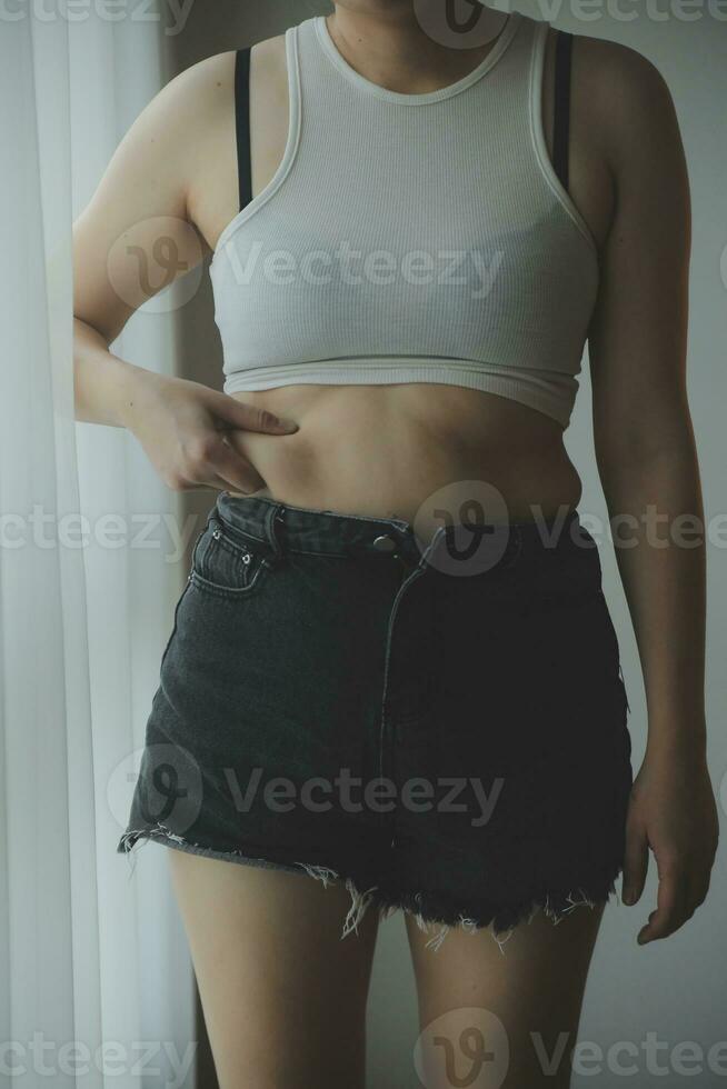 Fat woman measuring , fat woman fat belly chubby paunchy sport recreation health care lose belly fat do not exercise concept photo