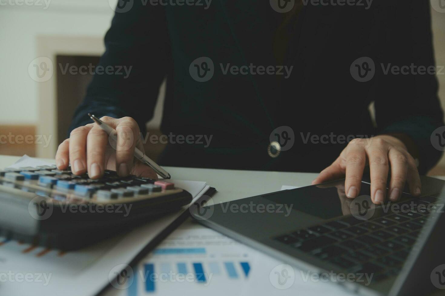 Unrecognizable businessman using calculator photo