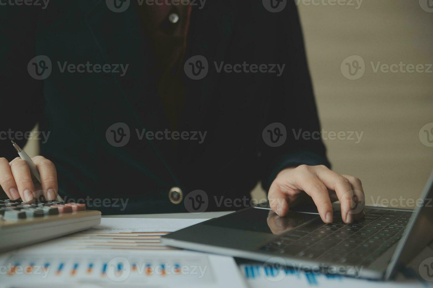 Unrecognizable businessman using calculator photo
