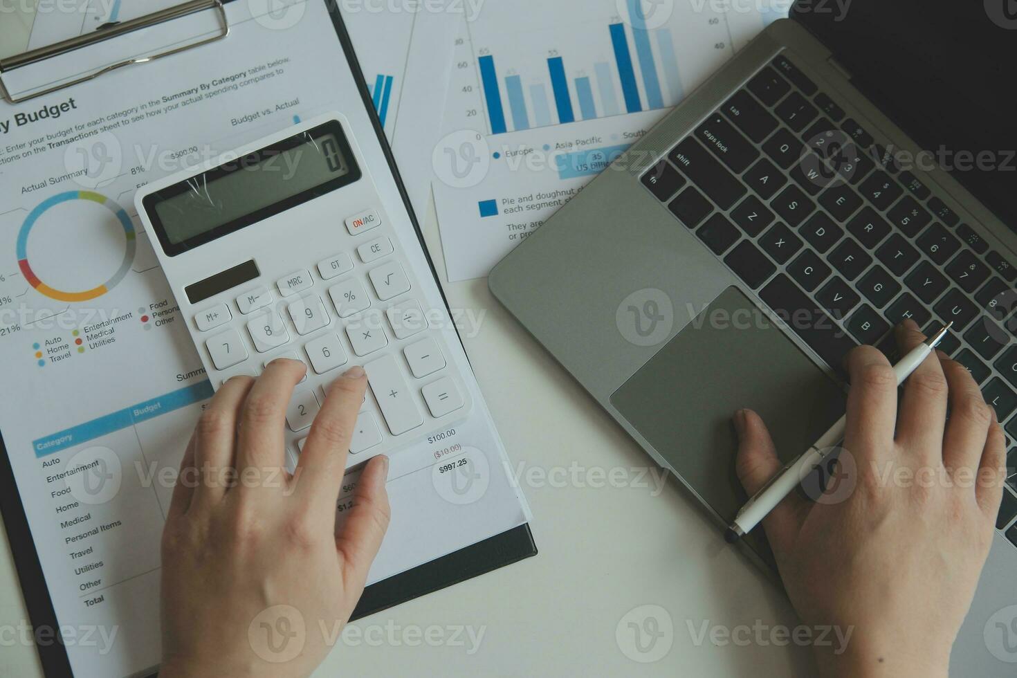 Unrecognizable businessman using calculator photo