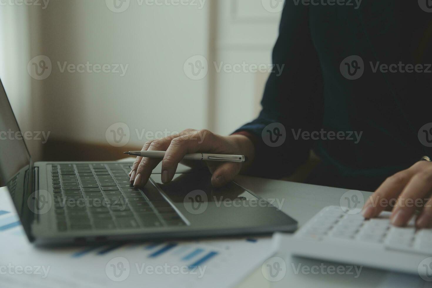 Unrecognizable businessman using calculator photo