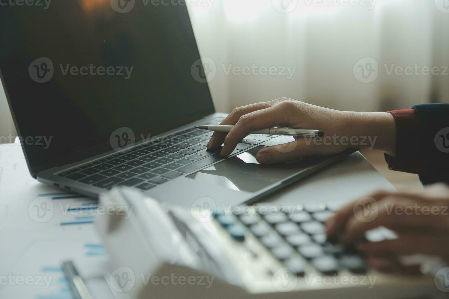 Unrecognizable businessman using calculator photo
