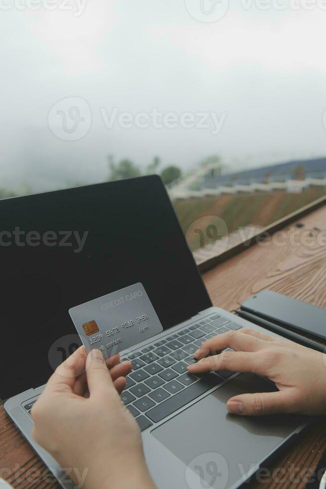 online payment, young woman holding credit card and touching on smartphone screen, copy space photo