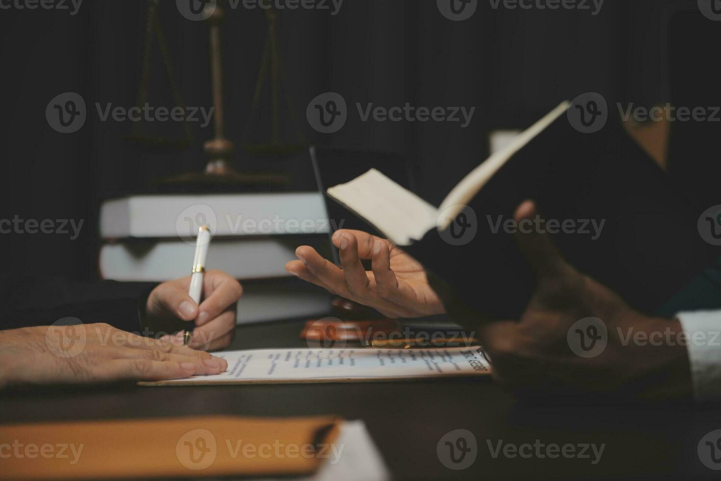 Business and lawyers discussing contract papers with brass scale on desk in office. Law, legal services, advice, justice and law concept picture with film grain effect photo