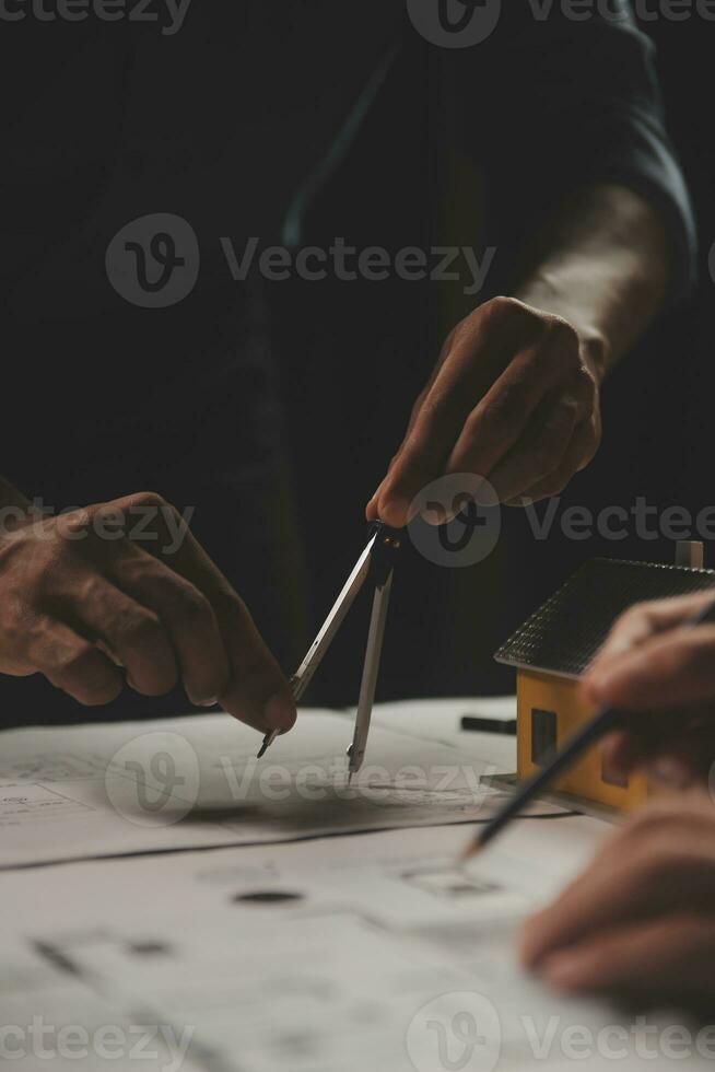 Engineer Teamwork Meeting, Drawing working on blueprint meeting for project working with partner on model building and engineering tools in working site, Construction and structure concept. photo