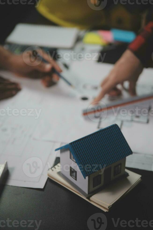 Engineer Teamwork Meeting, Drawing working on blueprint meeting for project working with partner on model building and engineering tools in working site, Construction and structure concept. photo