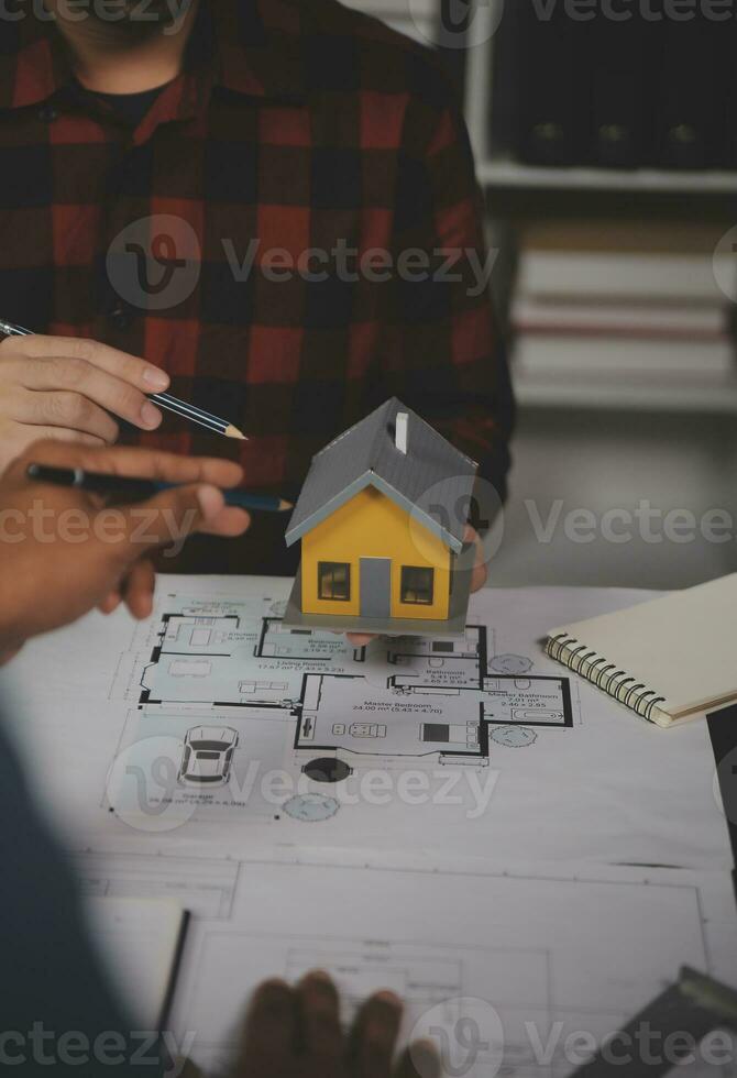 Engineer Teamwork Meeting, Drawing working on blueprint meeting for project working with partner on model building and engineering tools in working site, Construction and structure concept. photo