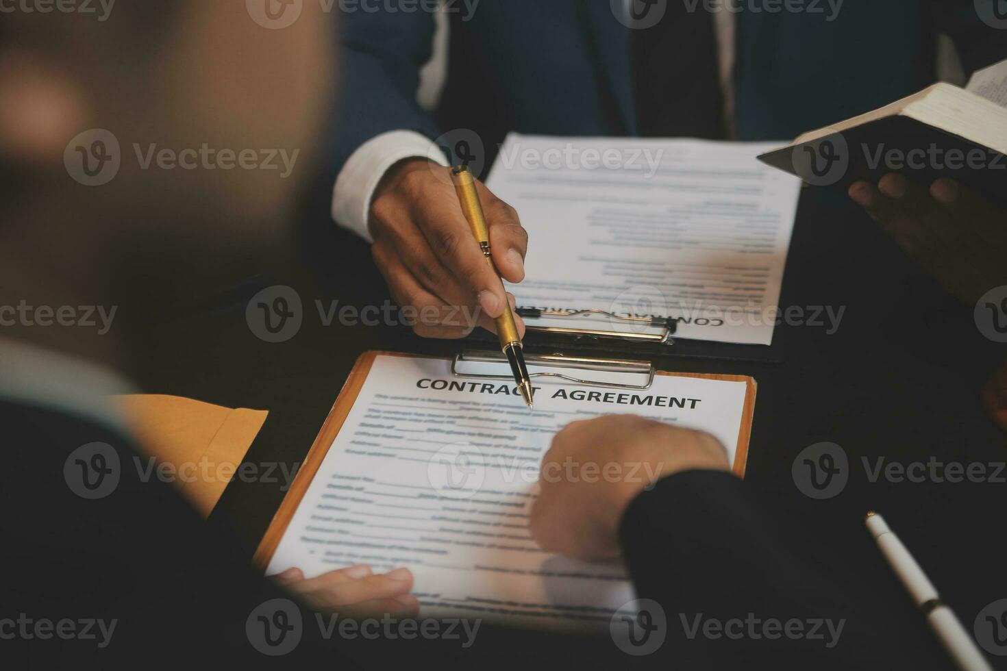 Business and lawyers discussing contract papers with brass scale on desk in office. Law, legal services, advice, justice and law concept picture with film grain effect photo