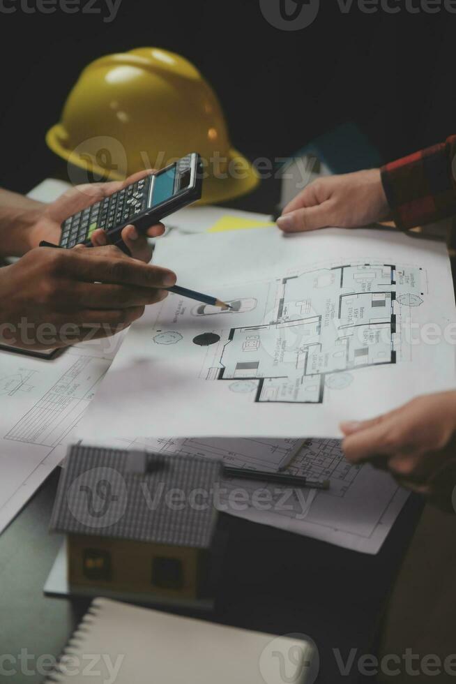 Engineer Teamwork Meeting, Drawing working on blueprint meeting for project working with partner on model building and engineering tools in working site, Construction and structure concept. photo