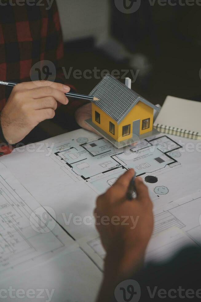 Engineer Teamwork Meeting, Drawing working on blueprint meeting for project working with partner on model building and engineering tools in working site, Construction and structure concept. photo