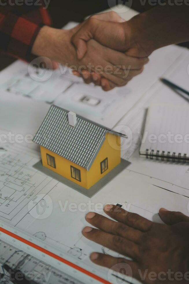 Engineer Teamwork Meeting, Drawing working on blueprint meeting for project working with partner on model building and engineering tools in working site, Construction and structure concept. photo