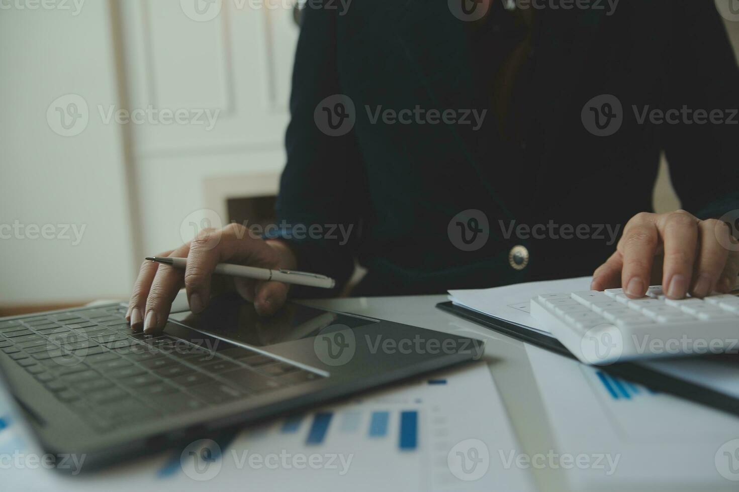 Unrecognizable businessman using calculator photo