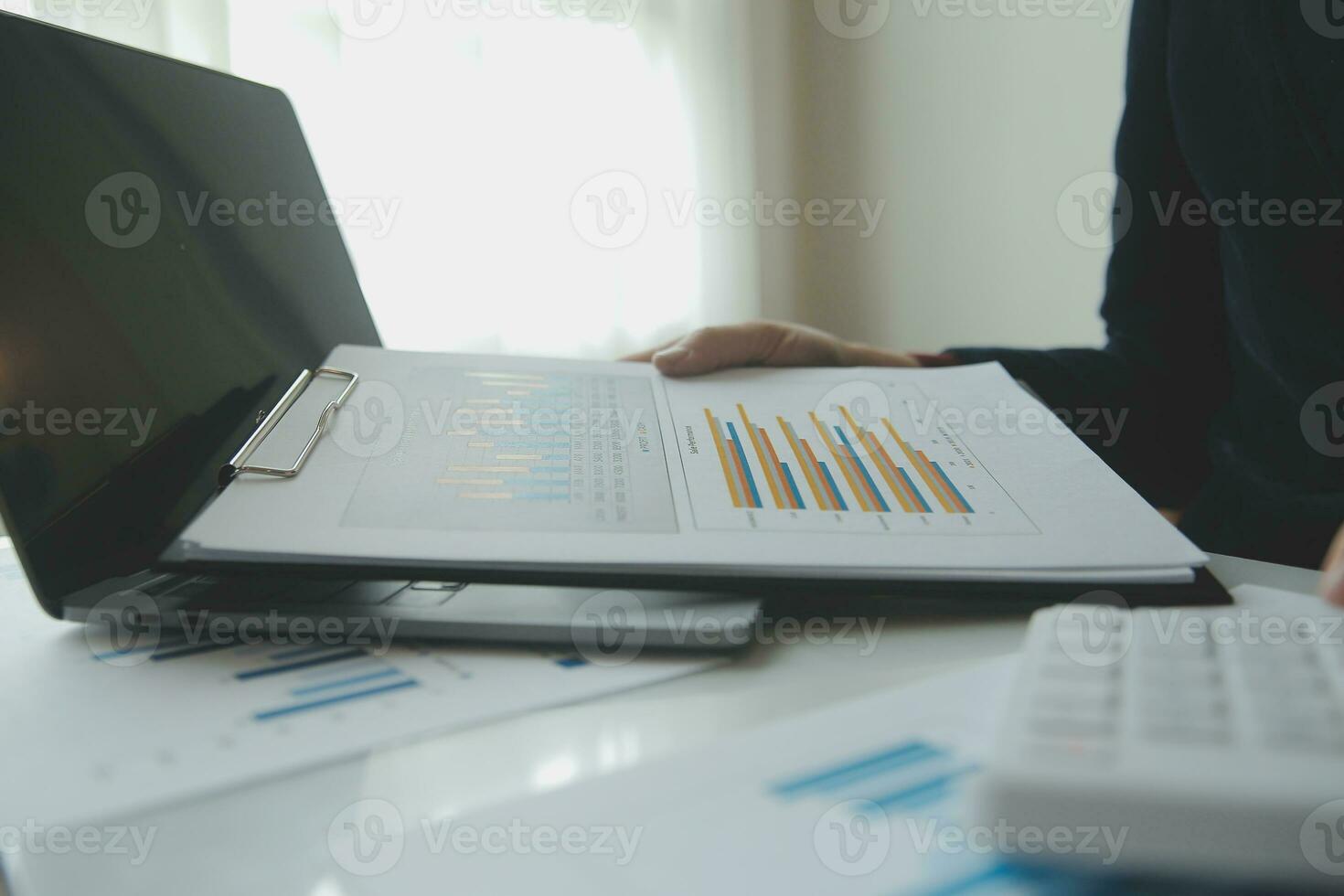 Unrecognizable businessman using calculator photo