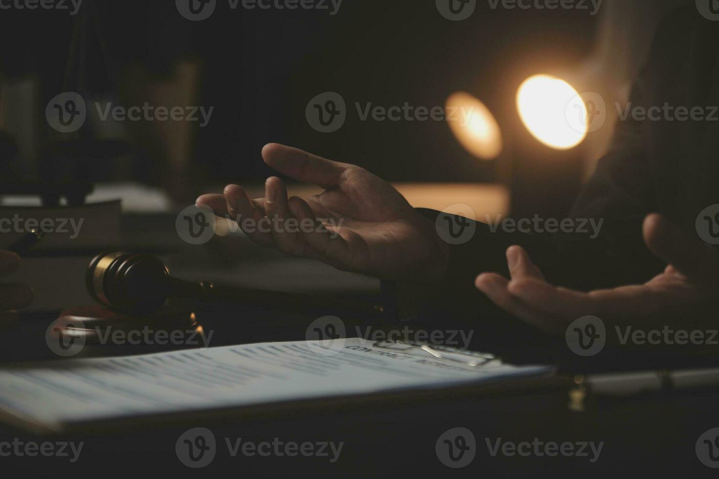 Business and lawyers discussing contract papers with brass scale on desk in office. Law, legal services, advice, justice and law concept picture with film grain effect photo