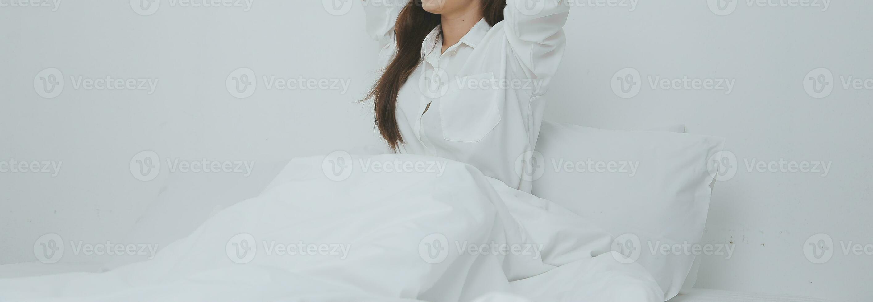 Woman stretching in bed after wake up photo