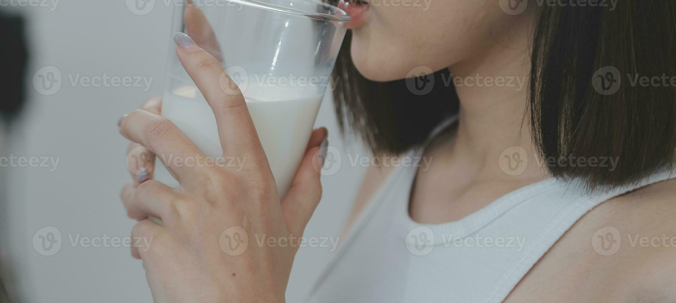Young attractive girl Spanish appearance delighted with the surprise. And The Morning Started With An Unexpected Healthy Breakfast. In surprise, she waved her hands and rejoices at what is happening. photo