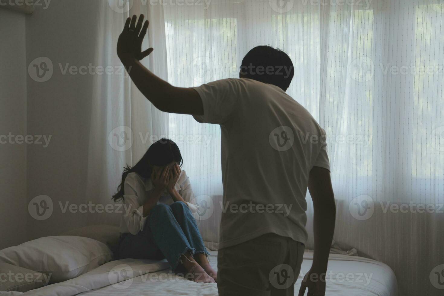 Upset woman having a fight with a man at home. Hispanic wife slapping the face of her husband during an argument because of their relationship problems photo