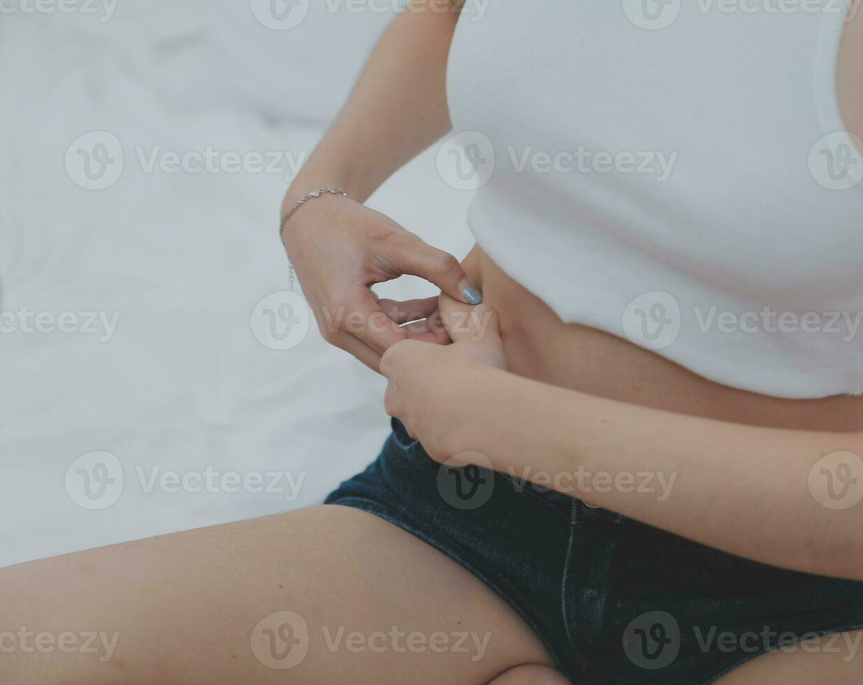 Young attractive girl Spanish appearance delighted with the surprise. And The Morning Started With An Unexpected Healthy Breakfast. In surprise, she waved her hands and rejoices at what is happening. photo