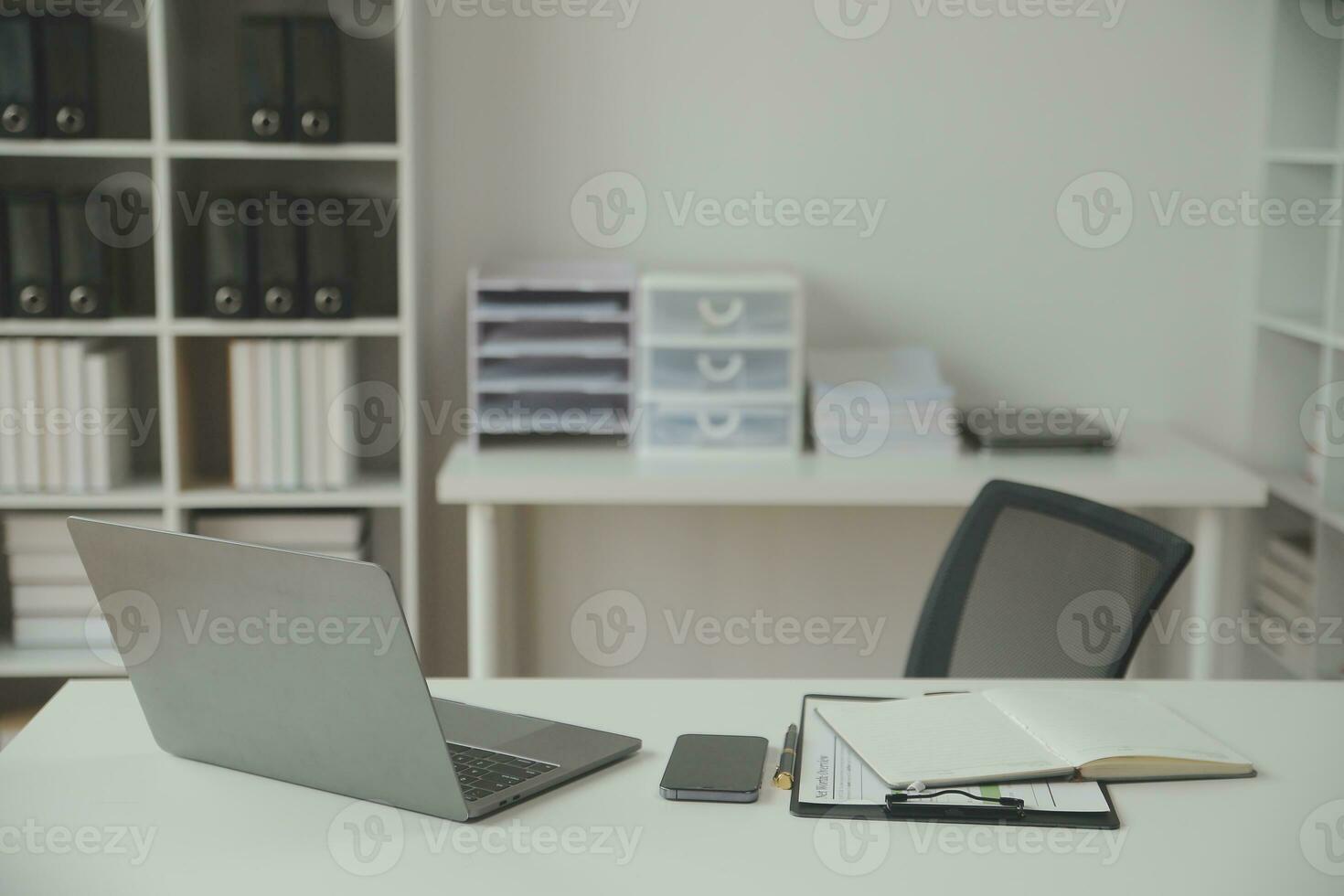 Asian Businesswoman Using laptop computer and working at office with calculator document on desk, doing planning analyzing the financial report, business plan investment, finance analysis concept. photo