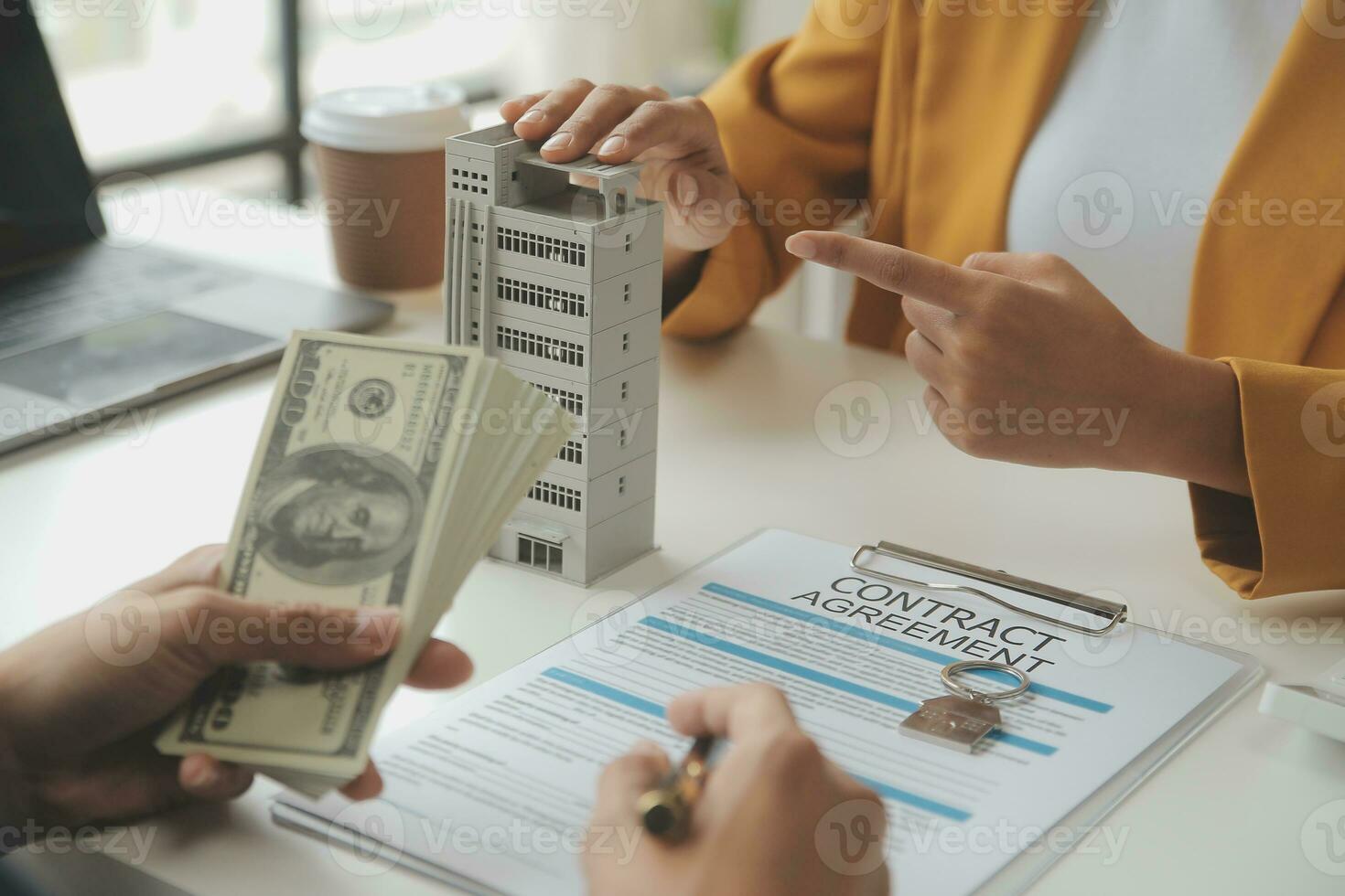 Real estate brokerage agent Deliver a sample of a model house to the customer, mortgage loan agreement Making lease and buy and sell house And contract home insurance mortgage loan concept photo