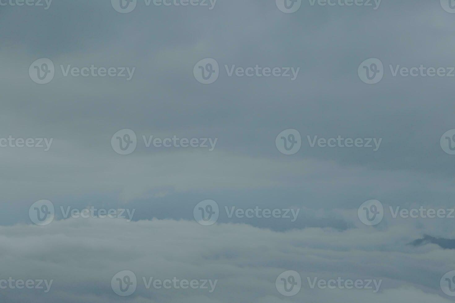 Mountain range with visible silhouettes through the morning blue fog. photo