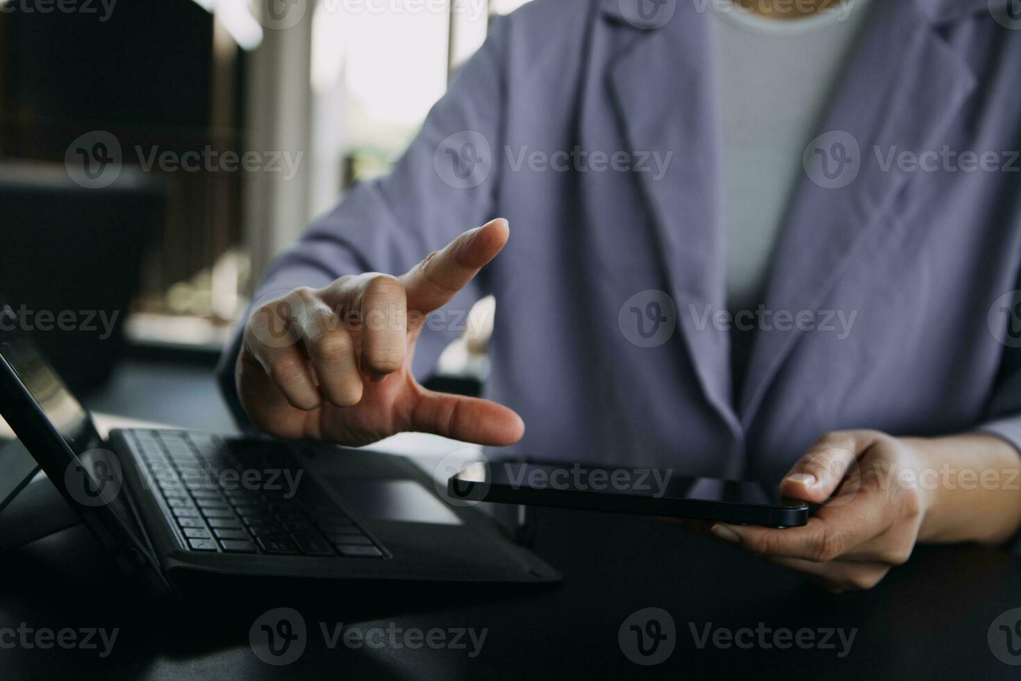 Asian Business woman using calculator and laptop for doing math finance on an office desk, tax, report, accounting, statistics, and analytical research concept photo