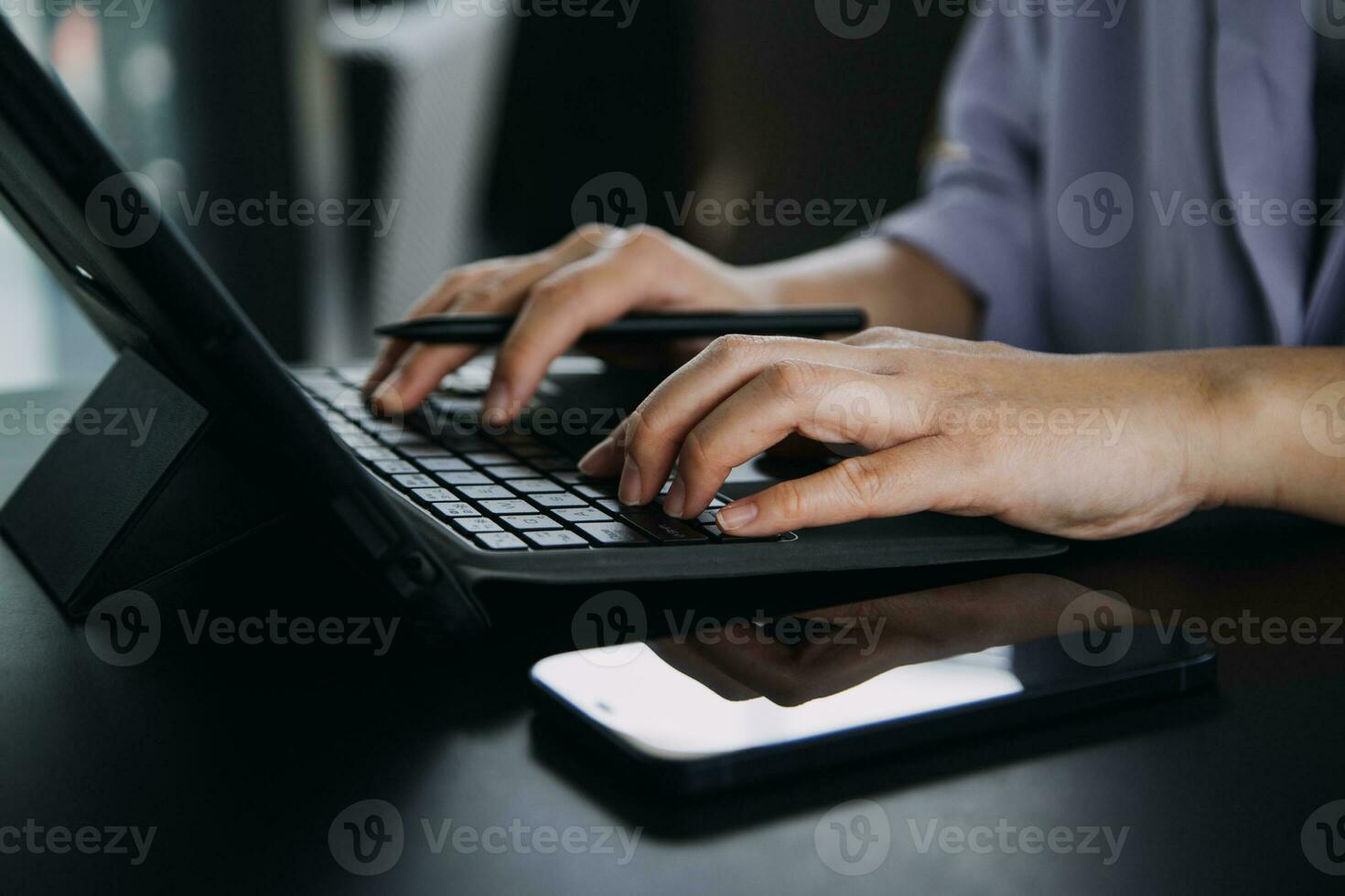 Asian Business woman using calculator and laptop for doing math finance on an office desk, tax, report, accounting, statistics, and analytical research concept photo